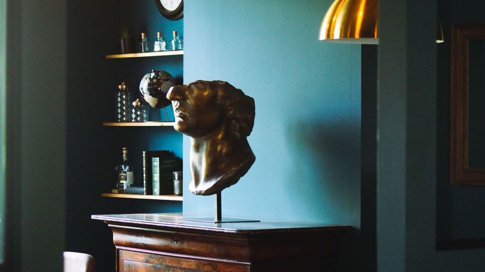 Salon St Martin de Maison Amour à Tours, décoré avec buste en bronze, meubles anciens et lumière tamisée dans une ambiance raffiné